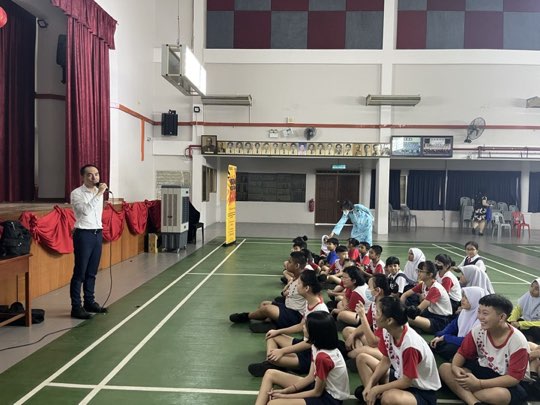 Ts. Lukas J. Tan delivering a scam-awareness talk at SJKC Yu Chye