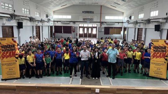 A school hall full of students learning about scams