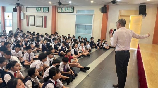 Primary school students at a scam-awareness session